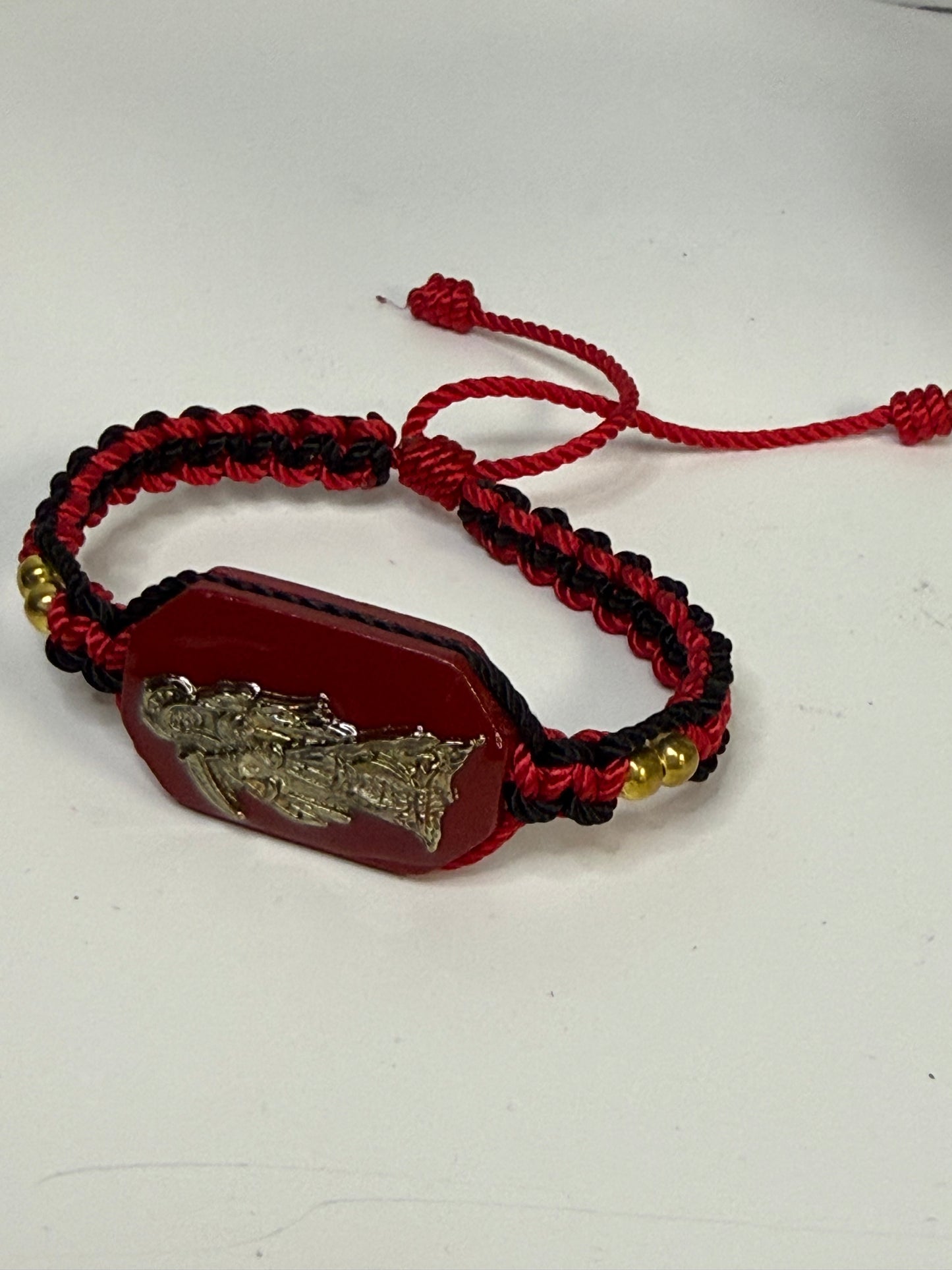 Pulsera De La Santa Muerte Tejida a Mano con (dorada) /Hand-woven Santa Muerte bracelet with (gold)