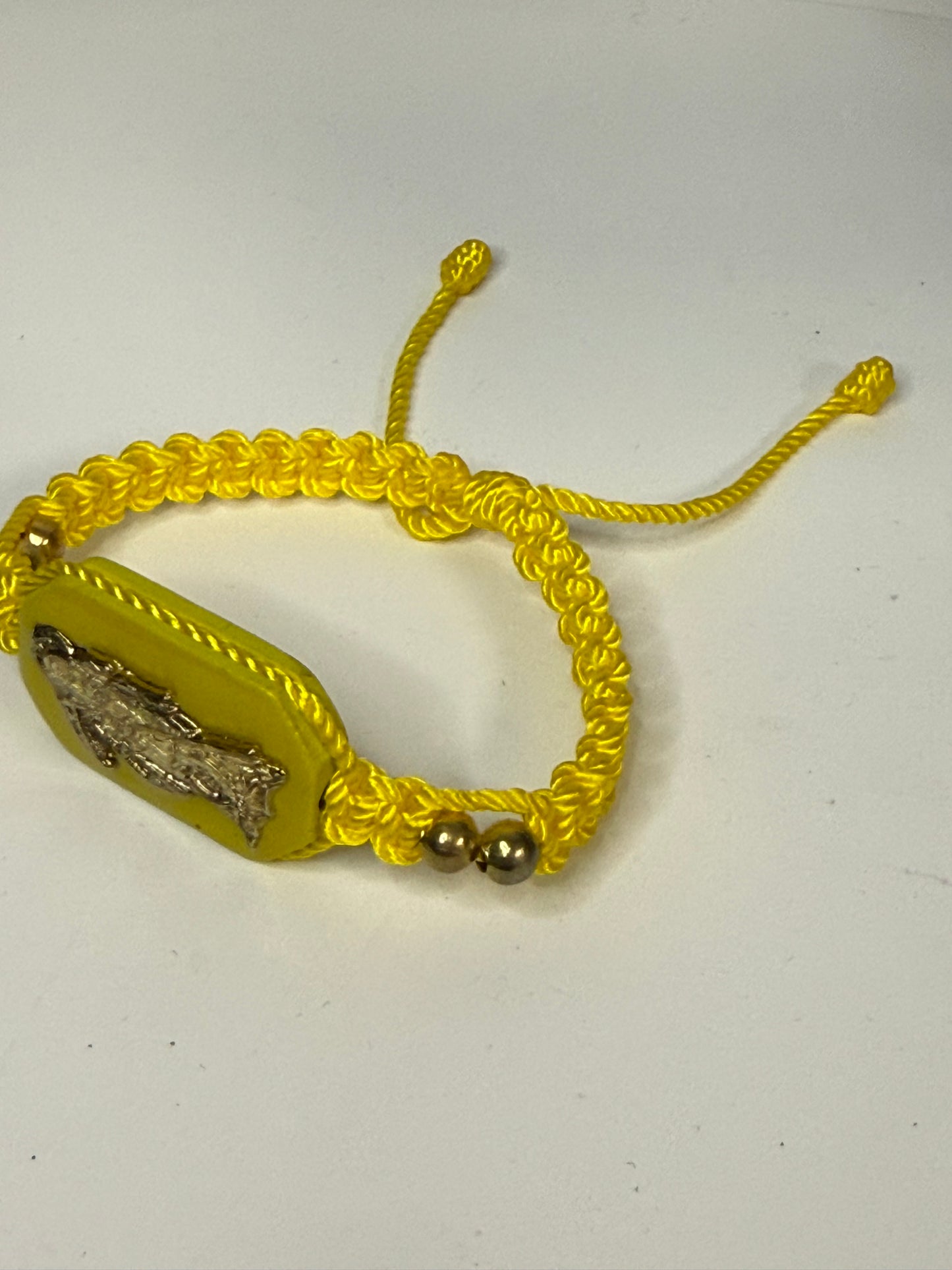 Pulsera De La Santa Muerte Tejida a Mano con (dorada) /Hand-woven Santa Muerte bracelet with (gold)